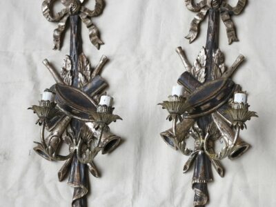 1950/70 Pair of sconces  silvered wood  has the music instruments drum and trumpets